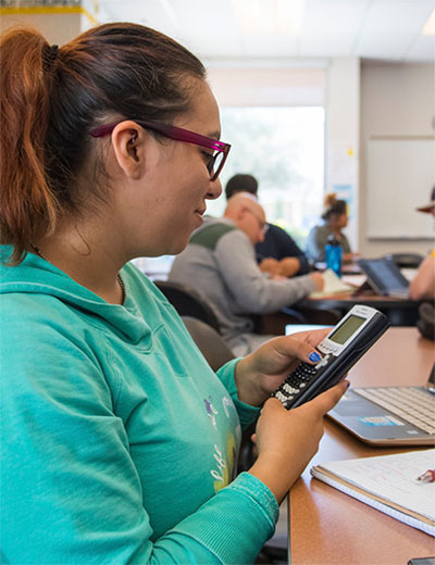 Young woman using a calculator