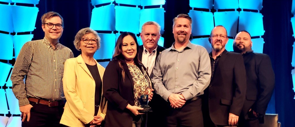 A delegation of Hancock staff and administrators accept the ACE award.