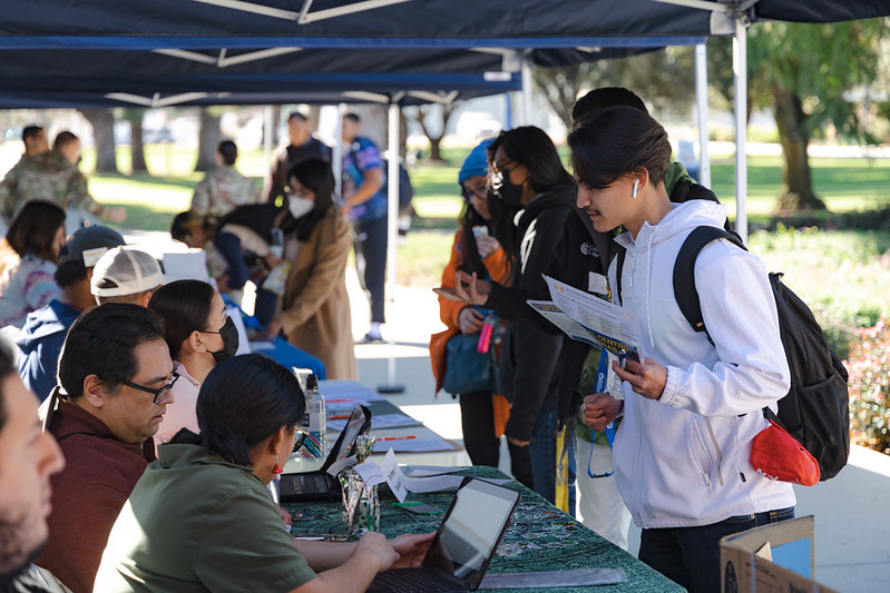 A student speaks with a Hancock staff member outside.