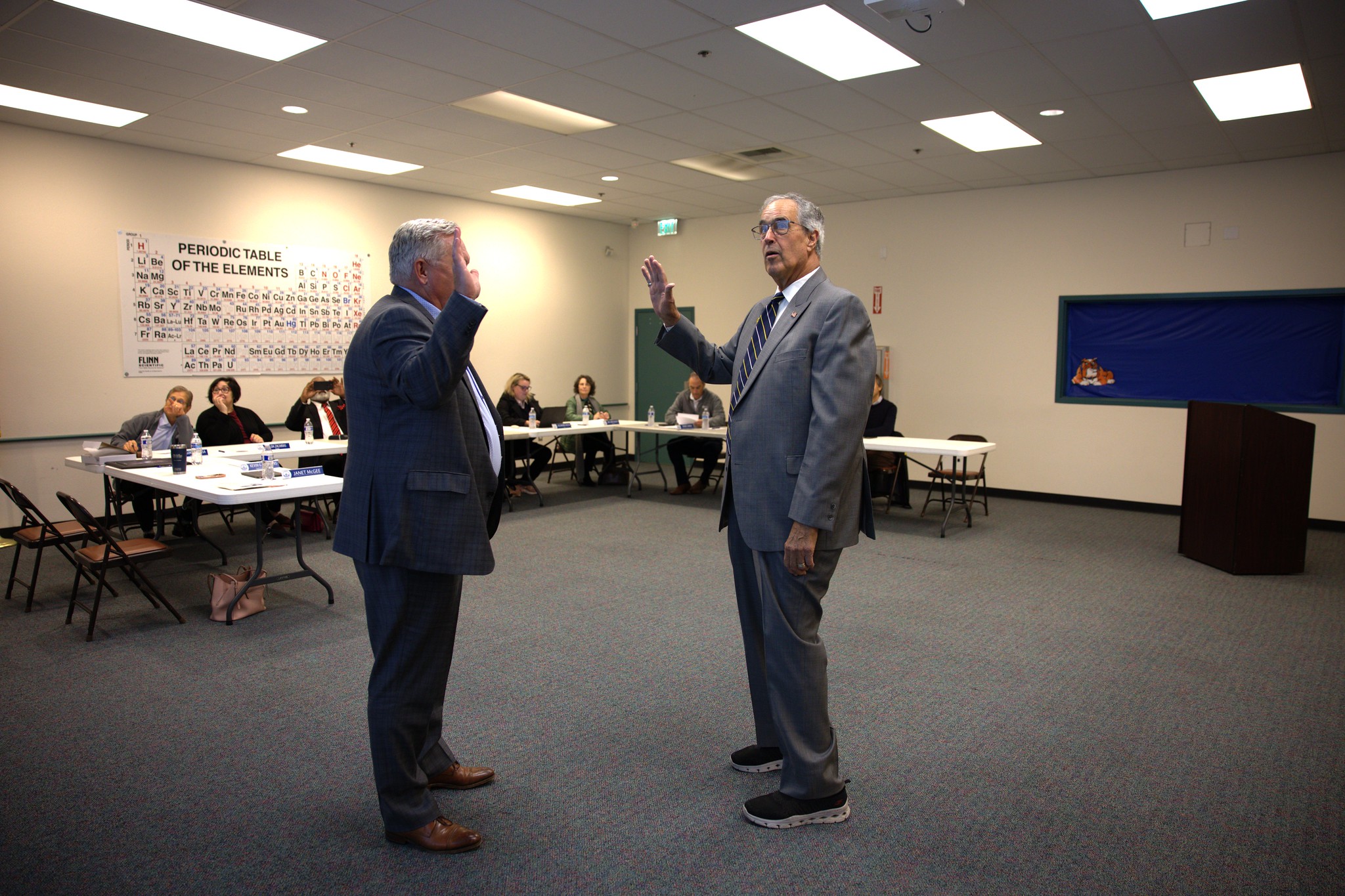 Hancock Superintendent/President Dr. Kevin G. Walthers swears in new college trustee Ken Ostini. 