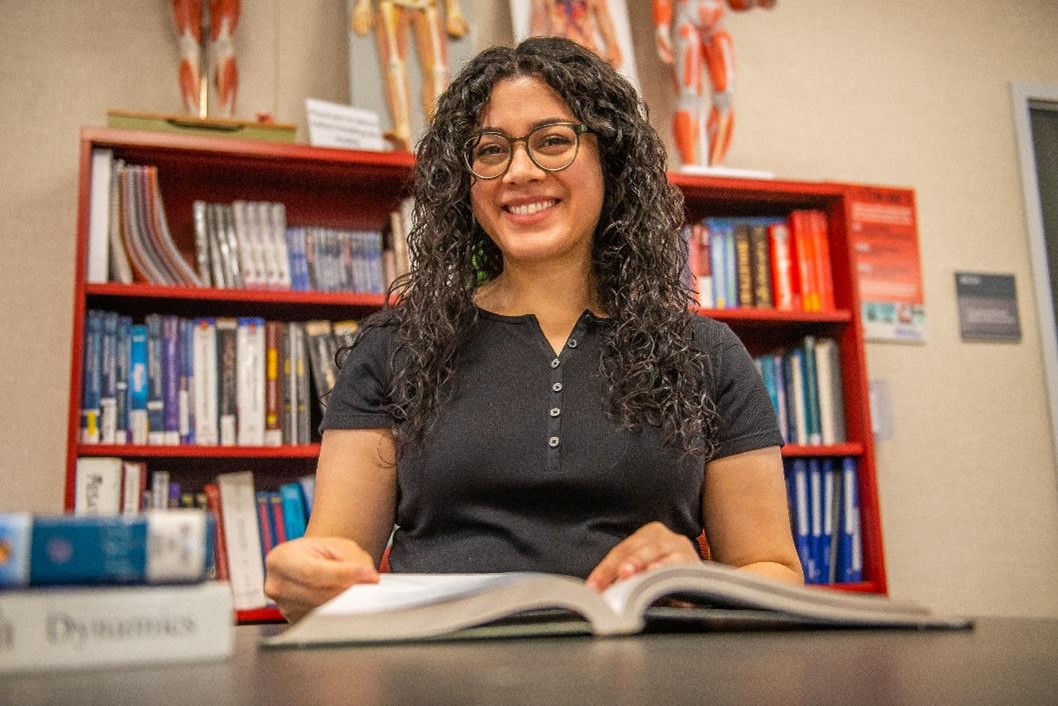 Hancock student Ruth Morales sits at a desk with a book.