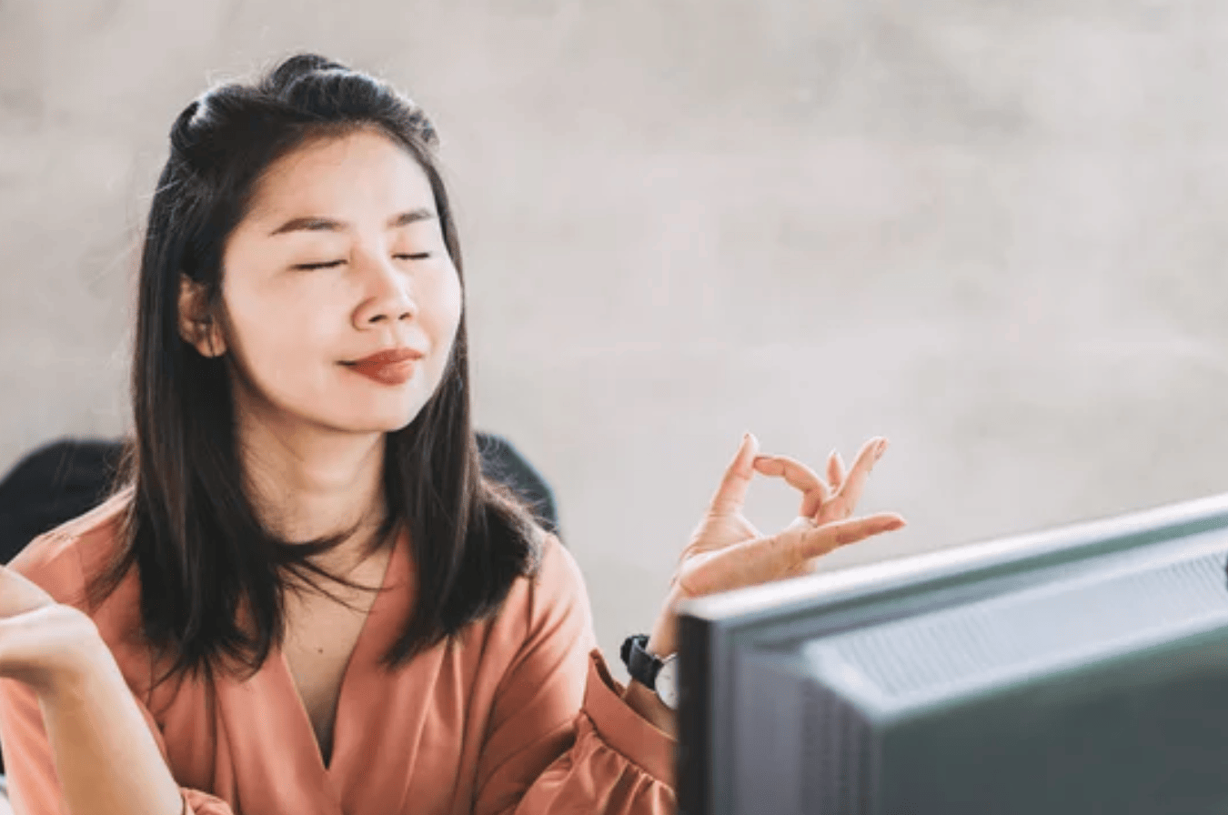 Woman meditating at computer