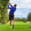 Player swinging a club at a golf course