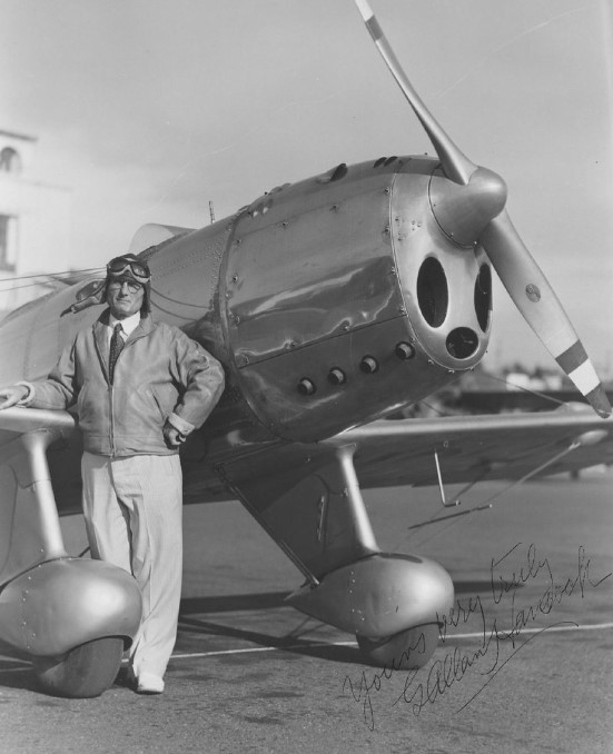 Autographed photo of Capt. Hancock next to a plane 