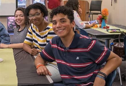 three students at a table