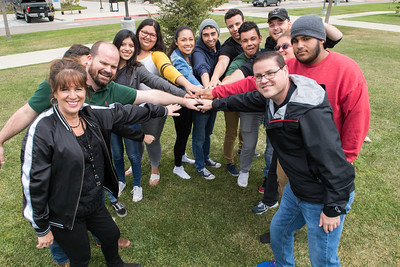 Group of students stands together, looking at the camera