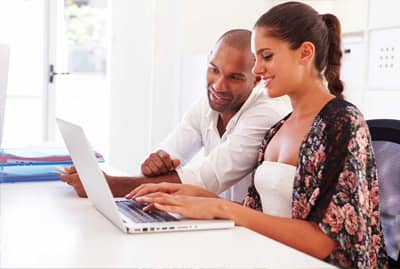 Man and woman on laptop together