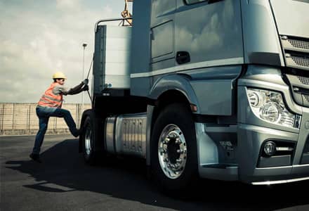 man next to a semi truck