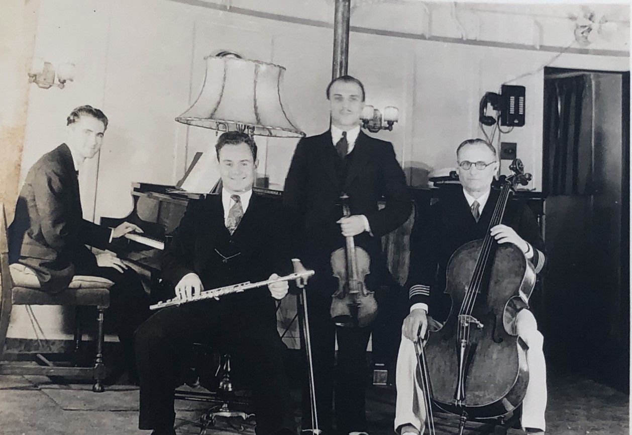 Hancock musical group sit together with instruments