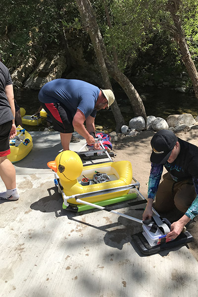 Man loading a rubber duck raft