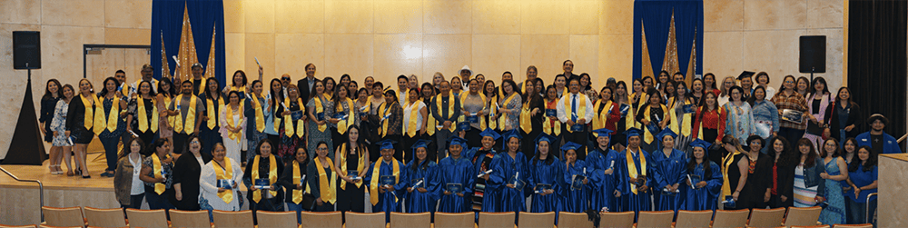 Large group of noncredit students wearing graduation robes