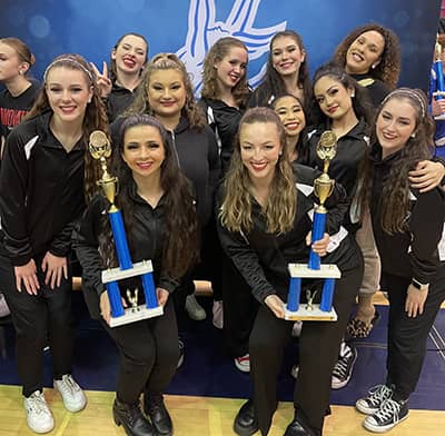 Dance team with trophies