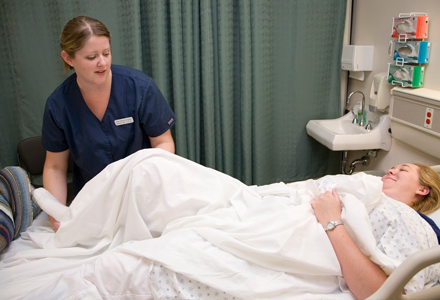 Woman adjusting hospital bed