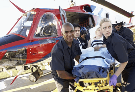 Paramedic in front of helicopter