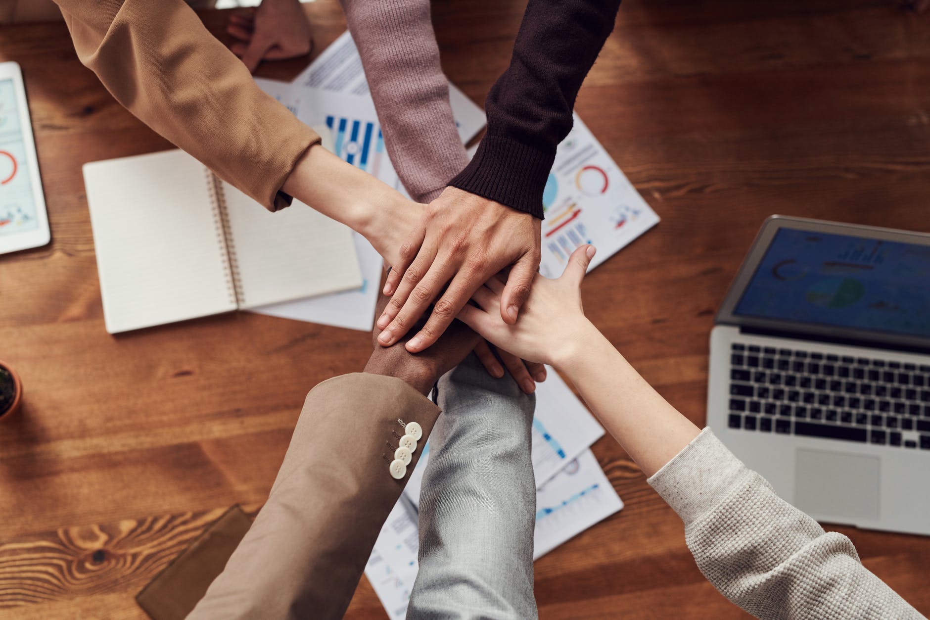 diverse hands in a huddle