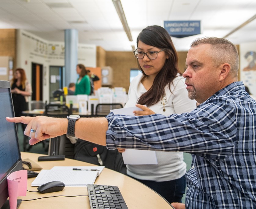 Instructor pointing at computer